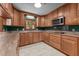 Cozy kitchen with wood cabinets, stone countertops, and stainless appliances at 825 Whispering Wind Rd, Burlington, NC 27217