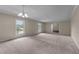 Expansive living room with neutral carpet, abundant natural light, and open floor plan at 825 Whispering Wind Rd, Burlington, NC 27217