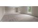 Bright, open living room featuring neutral carpet, chandelier, and natural light at 825 Whispering Wind Rd, Burlington, NC 27217