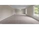Spacious living room with neutral carpet, crown molding, and bright natural light at 825 Whispering Wind Rd, Burlington, NC 27217