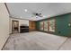 Bright living room with large windows, carpet flooring, and an elegant piano at 825 Whispering Wind Rd, Burlington, NC 27217