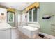 Well-lit bathroom featuring a bathtub, shower, windows, and a stylish chandelier at 877 Millcroft, Pittsboro, NC 27312