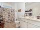 Bright bathroom with vanity, toilet, decorative shower curtain, and natural light at 877 Millcroft, Pittsboro, NC 27312