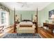 Spacious bedroom with a four-poster bed, bedside tables, lamps, and natural light at 877 Millcroft, Pittsboro, NC 27312