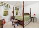 Comfortable bedroom with a four-poster bed, charming window decor, and soft natural light at 877 Millcroft, Pittsboro, NC 27312