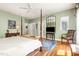 Sunlit bedroom featuring a four-poster bed, stylish decor, a unique mirror, and ample natural light at 877 Millcroft, Pittsboro, NC 27312