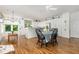 Bright, open kitchen with white cabinets, hardwood floors, and an adjacent dining area at 877 Millcroft, Pittsboro, NC 27312