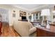 Inviting living room featuring hardwood floors and neutral tones with an abundance of natural light at 877 Millcroft, Pittsboro, NC 27312