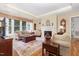 Comfortable living room with a large window, fireplace, and hardwood floors at 877 Millcroft, Pittsboro, NC 27312