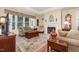 Comfortable living room with a large window, fireplace, and hardwood floors at 877 Millcroft, Pittsboro, NC 27312