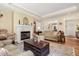 Bright living room with fireplace, comfortable seating, and hardwood floors at 877 Millcroft, Pittsboro, NC 27312