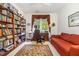 Inviting office space with custom built-in bookshelves, a comfortable sofa, and large window for natural light at 877 Millcroft, Pittsboro, NC 27312