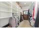 Organized walk-in closet with ample shelving, hanging space, and a mirror at 877 Millcroft, Pittsboro, NC 27312