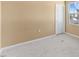 A simple, carpeted bedroom with a neutral color scheme and a window offering natural light at 1004 Bridgewater Dr, Durham, NC 27704