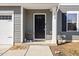 Close-up of a black front door with address number and charming decorative elements at 1004 Bridgewater Dr, Durham, NC 27704