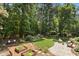 Seating, garden beds, and lush greenery define this spacious backyard at 103 Saint Brides Ct, Cary, NC 27518
