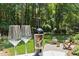 A view of the back yard with a bottle of wine and two wine glasses in the foreground at 103 Saint Brides Ct, Cary, NC 27518