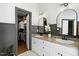 Bathroom with double vanities, granite counters, and a door opening to a spacious closet at 103 Saint Brides Ct, Cary, NC 27518