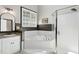 Bathroom featuring a luxurious soaking tub, glass shower, and neutral color palette at 103 Saint Brides Ct, Cary, NC 27518