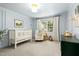 Serene Bedroom with a white crib, soft lighting, and a view of the outdoors at 103 Saint Brides Ct, Cary, NC 27518
