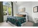 Comfortable bedroom with an arched window, soft textiles, and natural light at 103 Saint Brides Ct, Cary, NC 27518