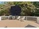 Wooden deck with umbrella, grill, and outdoor seating overlooking the green backyard at 103 Saint Brides Ct, Cary, NC 27518