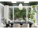 Bright dining room features a large window with beautiful backyard views and stylish pendant lighting at 103 Saint Brides Ct, Cary, NC 27518