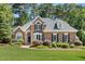 Charming brick home with manicured lawn, mature trees, and welcoming curb appeal at 103 Saint Brides Ct, Cary, NC 27518