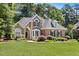 Beautiful brick home boasts manicured landscaping and a classic, inviting facade at 103 Saint Brides Ct, Cary, NC 27518