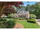 Stately brick home is complemented by a well-maintained lawn and mature landscaping at 103 Saint Brides Ct, Cary, NC 27518