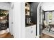 Hallway with built in coffee station featuring custom shelving and an arched doorway leading to an office at 103 Saint Brides Ct, Cary, NC 27518