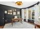 Well-lit office space with dark accent wall, wainscoting, and a bay window at 103 Saint Brides Ct, Cary, NC 27518
