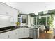Modern kitchen boasts stainless steel appliances, granite countertops, and white cabinetry, adjacent to the dining area at 103 Saint Brides Ct, Cary, NC 27518