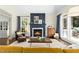 Cozy living room with a fireplace, hardwood floors, and large windows at 103 Saint Brides Ct, Cary, NC 27518
