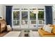 Inviting living room with large windows showcasing the outdoor deck and seating at 103 Saint Brides Ct, Cary, NC 27518