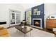 Living room with a fireplace, hardwood floors, and french doors at 103 Saint Brides Ct, Cary, NC 27518