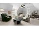 Cozy living room featuring neutral colors, a ceiling fan, comfortable seating, and a small play area at 103 Saint Brides Ct, Cary, NC 27518