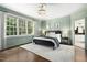 Bright main bedroom with hardwood floors, a decorative chandelier, and a view to the bathroom at 103 Saint Brides Ct, Cary, NC 27518
