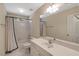 Clean bathroom featuring a tub/shower combination, vanity storage, and natural light from a window at 10809 Grassy Creek Pl, Raleigh, NC 27614