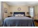 Cozy bedroom features a comfortable bed with decorative pillows and a stylish area rug on wood floors at 10809 Grassy Creek Pl, Raleigh, NC 27614