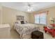 Bright bedroom featuring a queen-sized bed, a window, and a red accent chair at 10809 Grassy Creek Pl, Raleigh, NC 27614