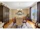 Formal dining room featuring hardwood floors, large window, and decorative rug at 10809 Grassy Creek Pl, Raleigh, NC 27614