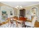 Dining room with hardwood floors, natural light, and an elegant chandelier at 10809 Grassy Creek Pl, Raleigh, NC 27614