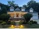 Charming home with inviting front porch, landscaped garden, and dormer windows at 10809 Grassy Creek Pl, Raleigh, NC 27614