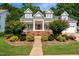 Beautiful home with landscaped garden, brick steps to covered porch, and two-car garage at 10809 Grassy Creek Pl, Raleigh, NC 27614