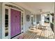 Charming front porch featuring a vibrant purple door and comfortable seating at 10809 Grassy Creek Pl, Raleigh, NC 27614