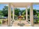 Covered front porch with stately white columns and decorative flower pots at 10809 Grassy Creek Pl, Raleigh, NC 27614
