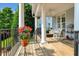 Inviting front porch featuring classic columns and a cozy rocking chair at 10809 Grassy Creek Pl, Raleigh, NC 27614