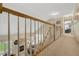 Open hallway overlooking a spacious living area with hardwood floors and natural light at 10809 Grassy Creek Pl, Raleigh, NC 27614
