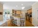 An inviting kitchen with stainless steel appliances, wooden cabinetry and a breakfast bar with seating at 10809 Grassy Creek Pl, Raleigh, NC 27614